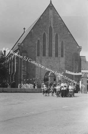 PROCESSION LEAVING CHURCH IN THE MAIN STREET